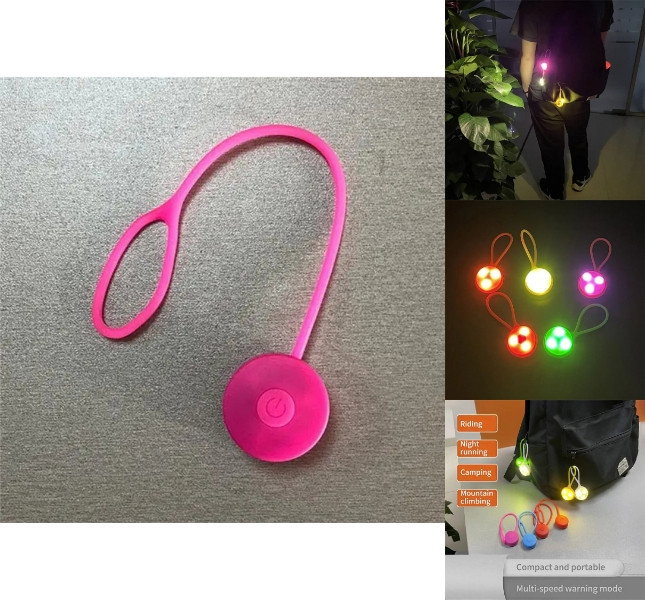 Mini silikone LED reflekslys i pink hængende på rygsæk